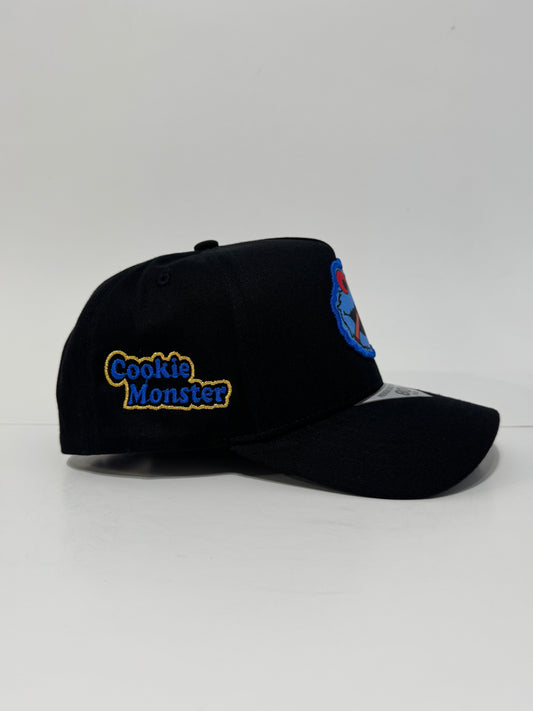 Black cap with 'Cookie Monster' text on a white background